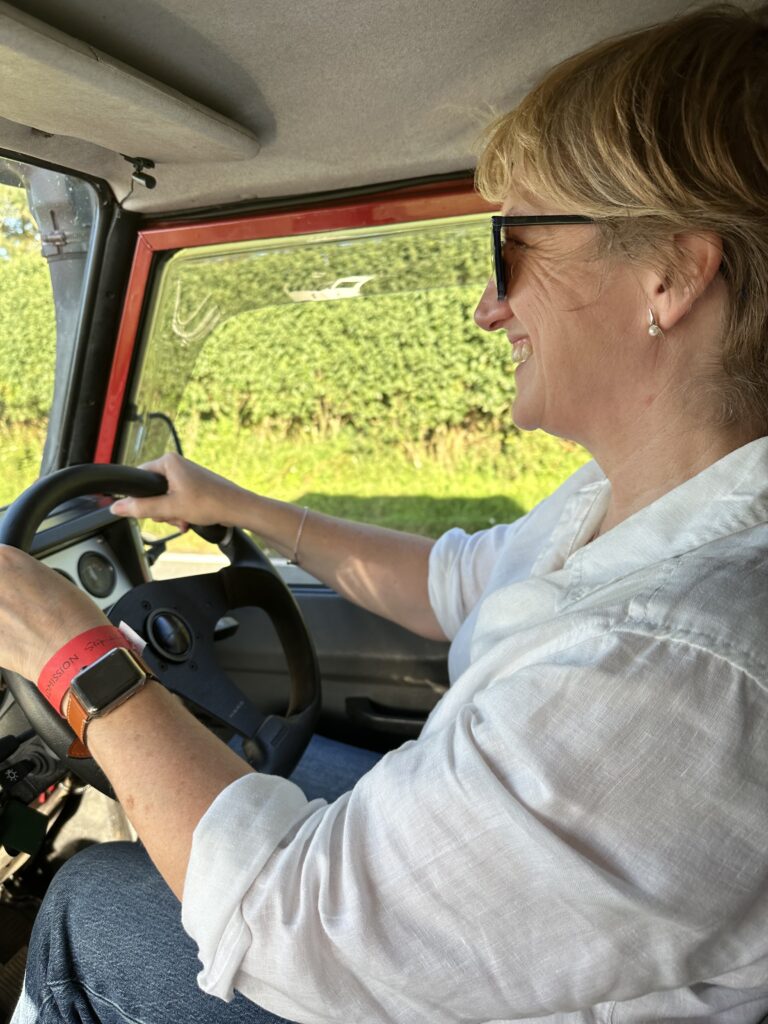Twiggy Bigwood.  Smiling woman driving a Land Rover.